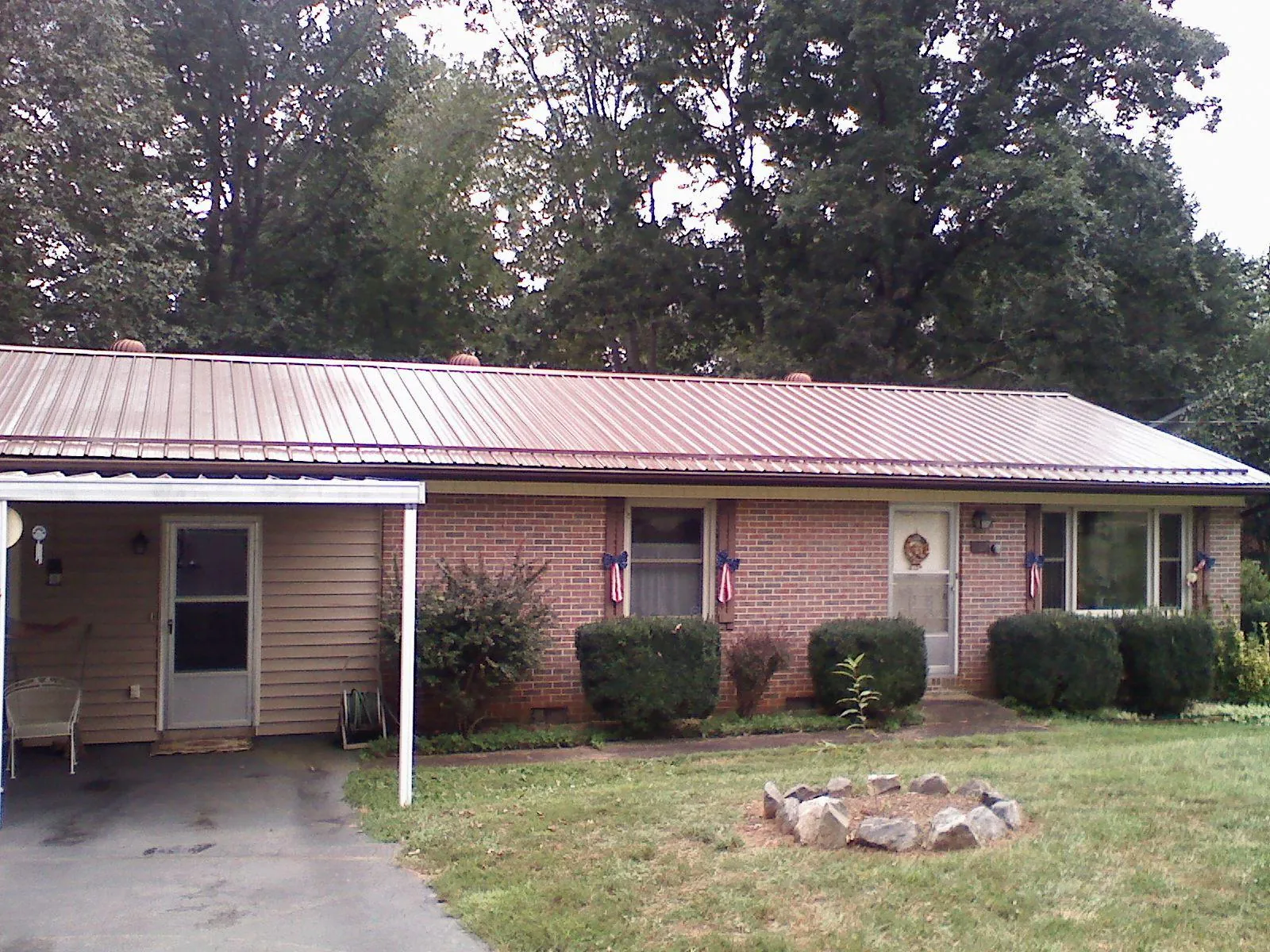 Bronze metal roof and carport on a brick ranch home — Roof Repair work by our crew in Southfields